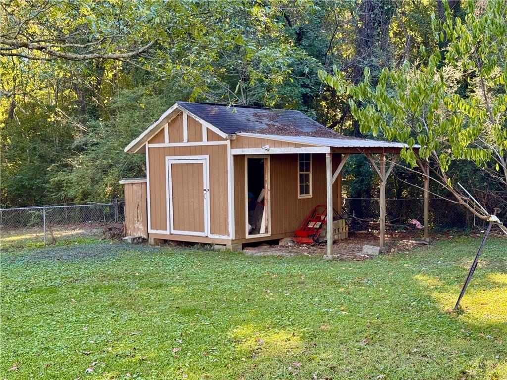 1825 North Road Snellville, GA 30078 - Photo 36 of 43 a view of a backyard with a slide and a large tree