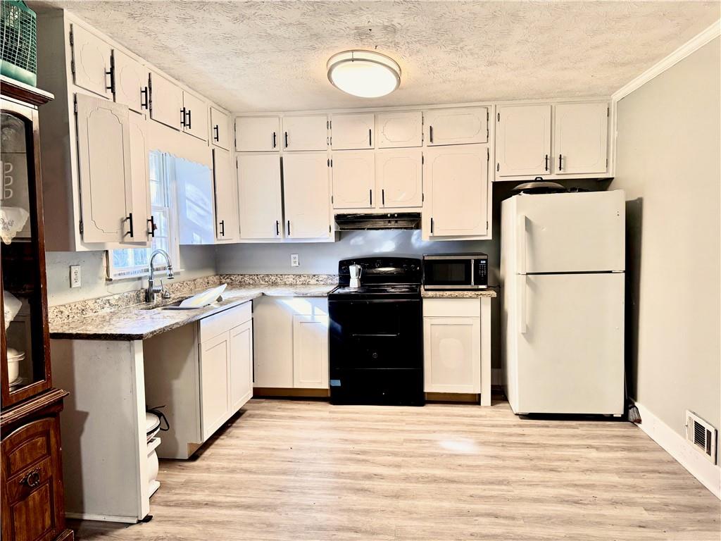 1825 North Road Snellville, GA 30078 - Photo 6 of 43 a kitchen with a refrigerator sink and cabinets