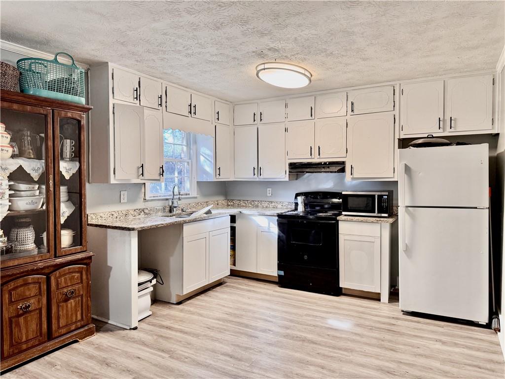 1825 North Road Snellville, GA 30078 - Photo 8 of 43 a kitchen with granite countertop a refrigerator stove top oven and sink