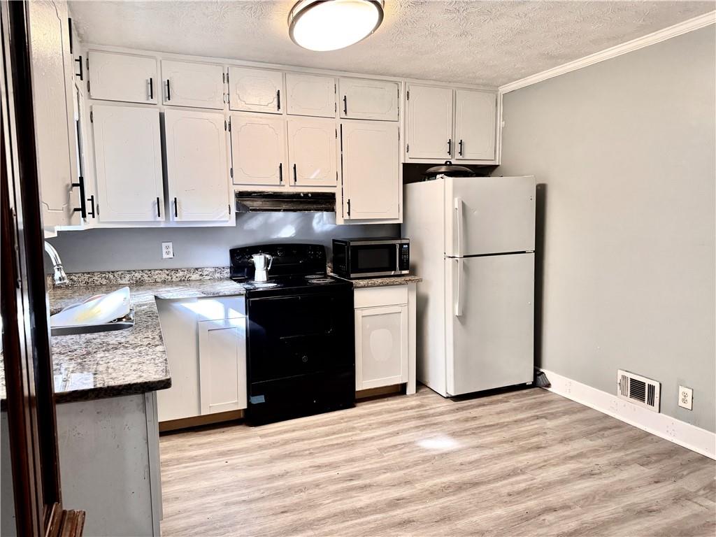 1825 North Road Snellville, GA 30078 - Photo 9 of 43 a kitchen with stainless steel appliances a refrigerator sink and cabinets