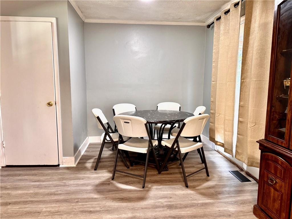 1825 North Road Snellville, GA 30078 - Photo 10 of 43 a view of a dining room with furniture and wooden floor