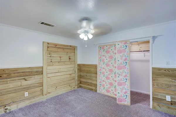 a view of room with stairs and a ceiling fan
