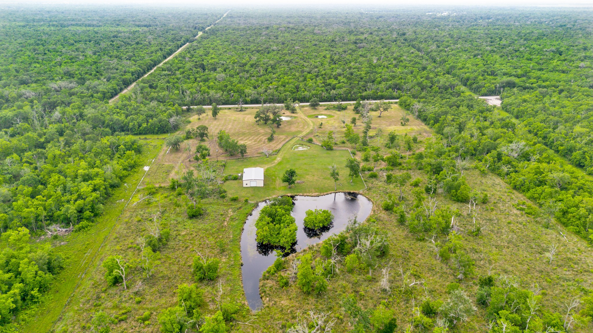 14067 County Road 809 Sweeny, TX 77480 - Photo 9 of 12 an aerial view of residential houses with outdoor space and trees