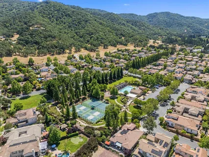 an aerial view of residential houses with outdoor space and street view