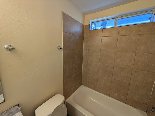 a bathroom with a toilet and shower