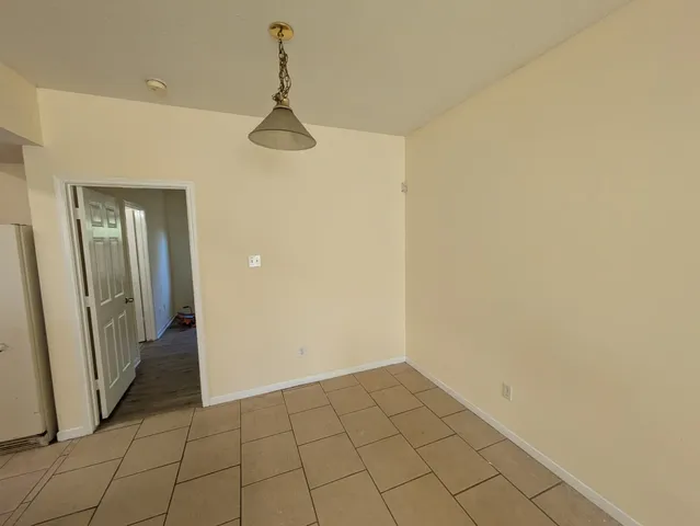 a view of an empty room and closet area