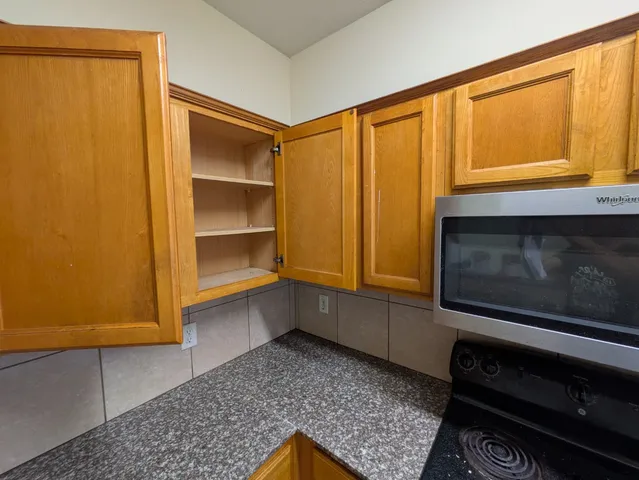 a living room with a bed and a dresser