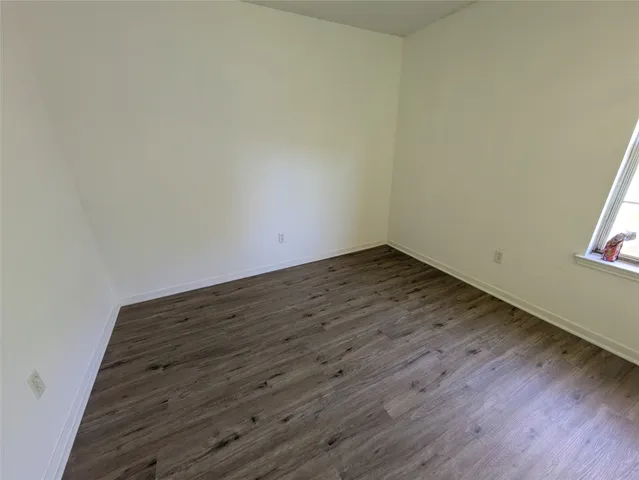 an empty room with wooden floor