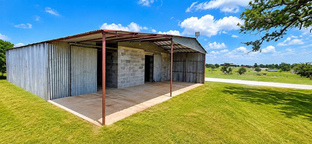 247 Rhoades Lane Springtown, TX 76082 - Photo 1 of 15 Appx 1000sf Workshop with 200amp service and 2 50 amp plugs. Water and electric at the lot.