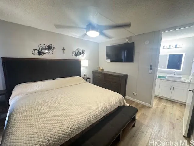 a bedroom with a large bed and a flat screen tv