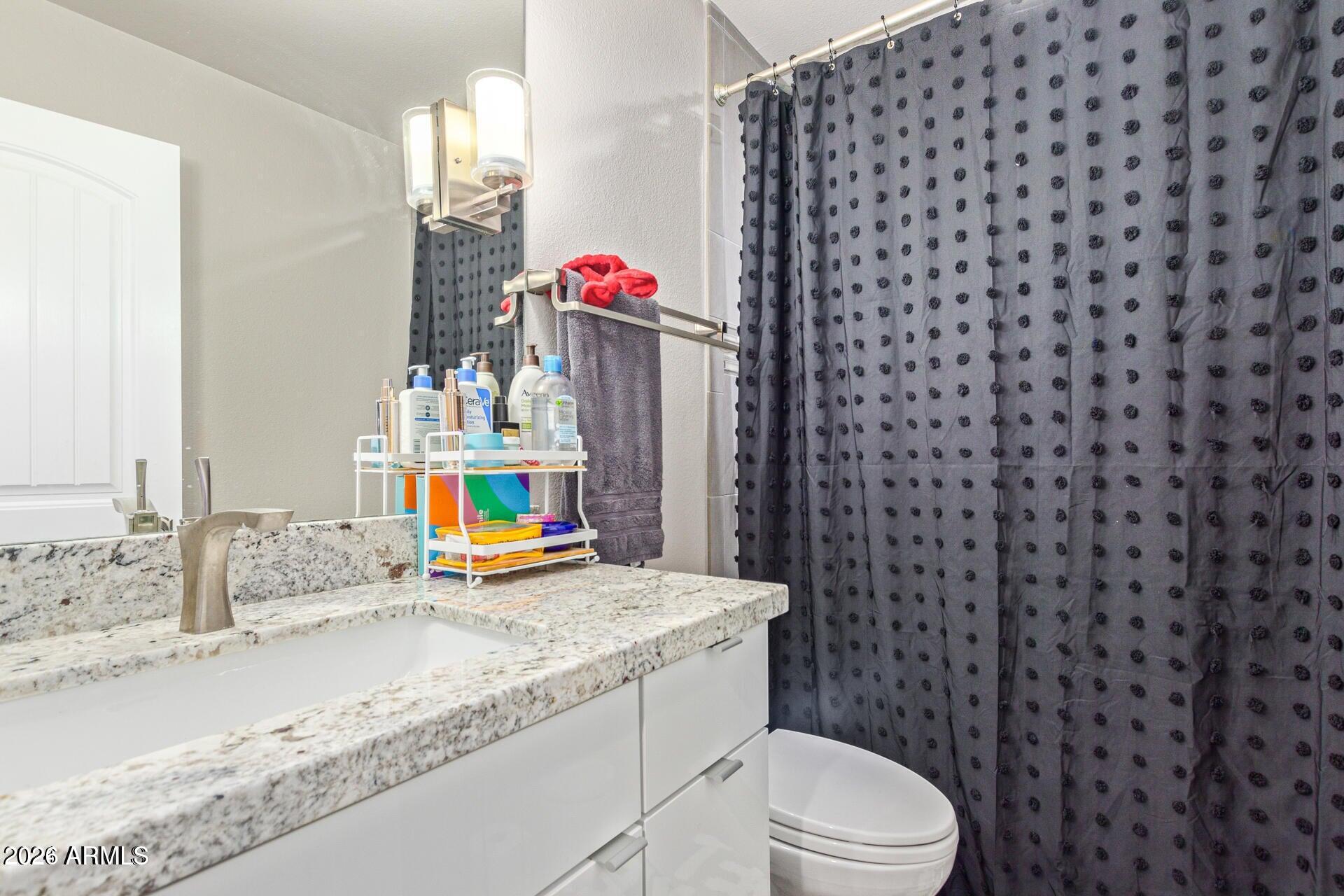 5913 East Thomas Road Scottsdale, AZ 85251 - Photo 21 of 26 a bathroom with a sink toilet and shower