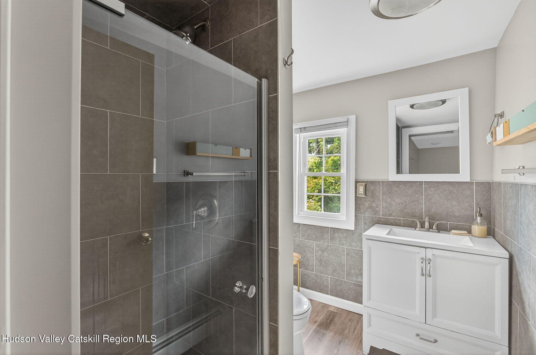 89 Spring Street Kingston, NY 12401 - Photo 13 of 24 a bathroom with a sink a toilet and shower