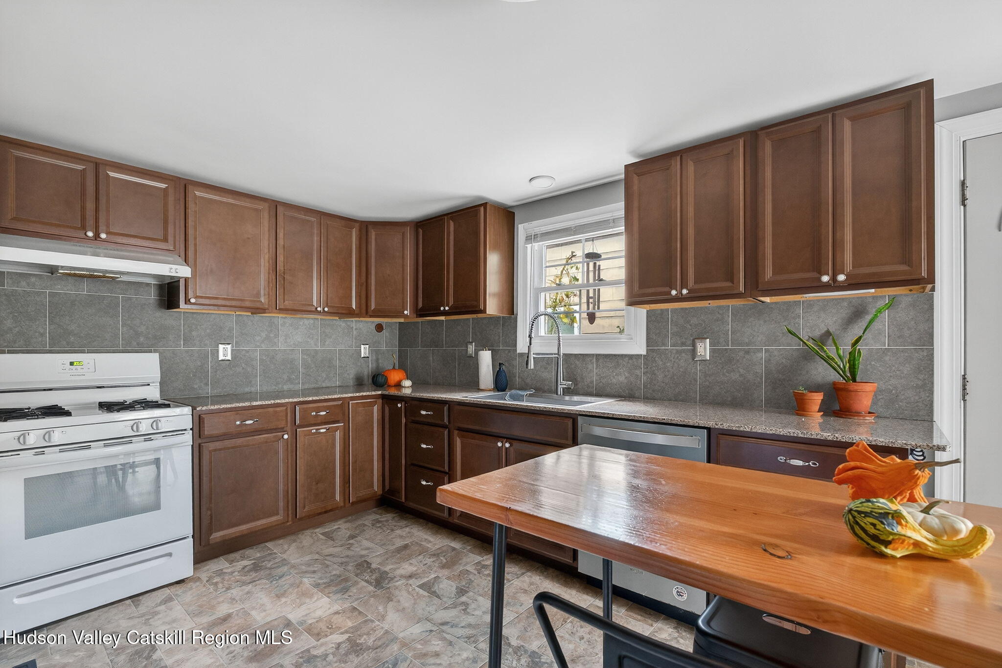 89 Spring Street Kingston, NY 12401 - Photo 6 of 24 a kitchen with a sink cabinets and window