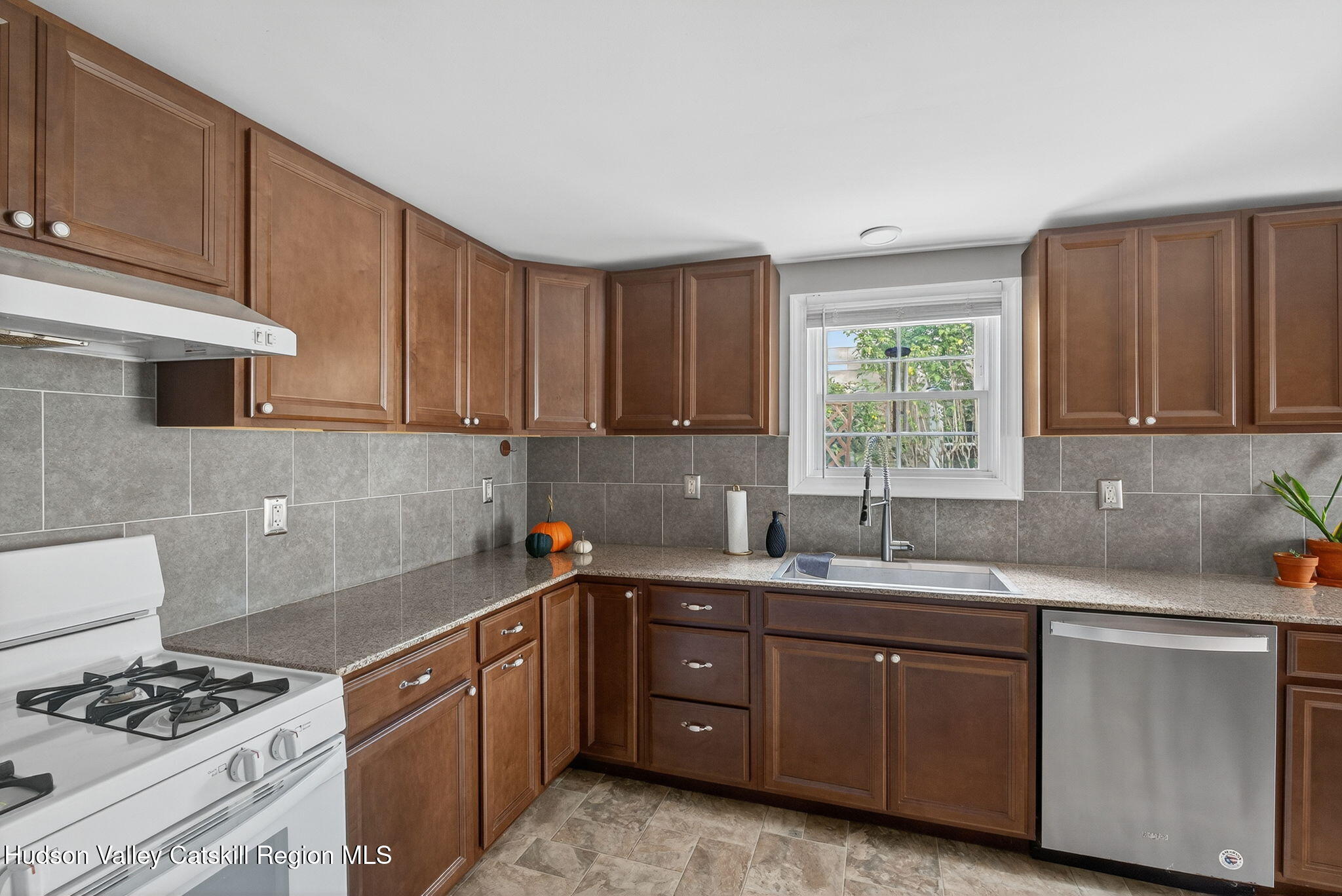 89 Spring Street Kingston, NY 12401 - Photo 7 of 24 a kitchen with sink a stove and cabinets