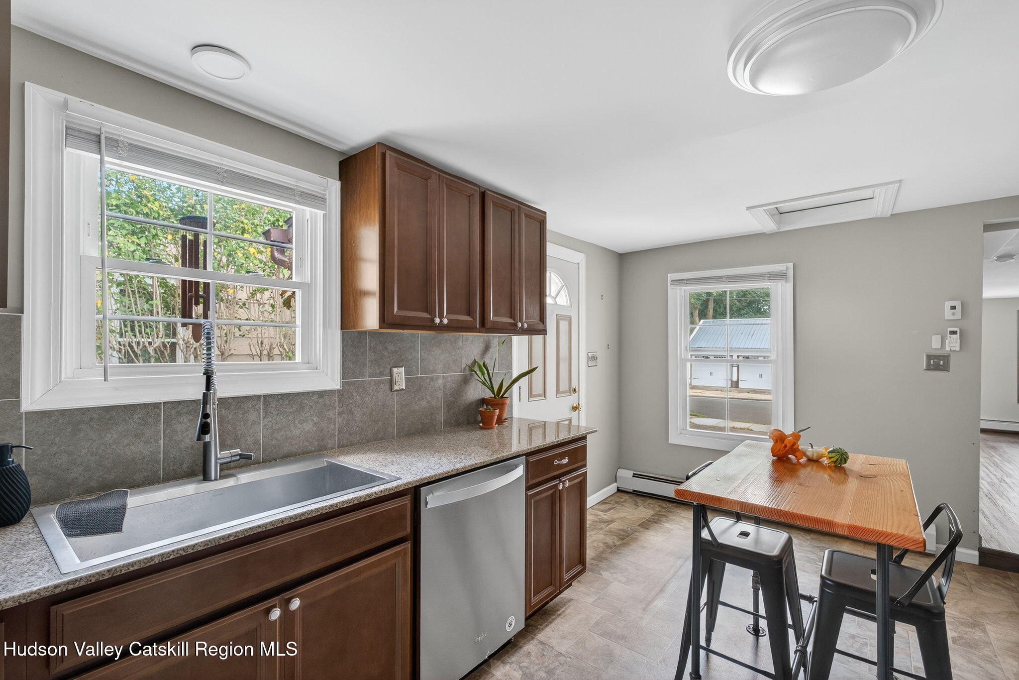 89 Spring Street Kingston, NY 12401 - Photo 8 of 24 a kitchen with a table chairs sink and cabinets