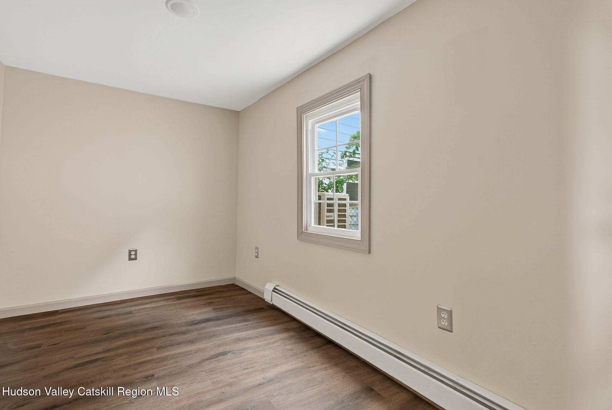 89 Spring Street Kingston, NY 12401 - Photo 9 of 24 an empty room with wooden floor and windows