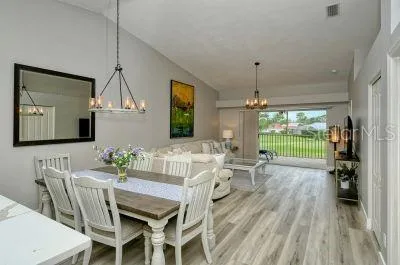 a view of a dining room with furniture window and wooden floor