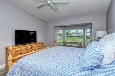 a bedroom with a bed and a flat screen tv