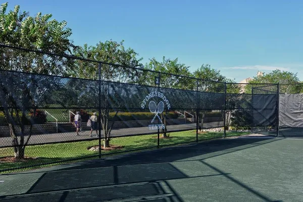 a view of a park with wooden fence
