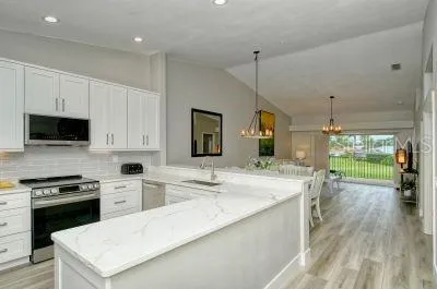 a kitchen with a stove a sink and a refrigerator