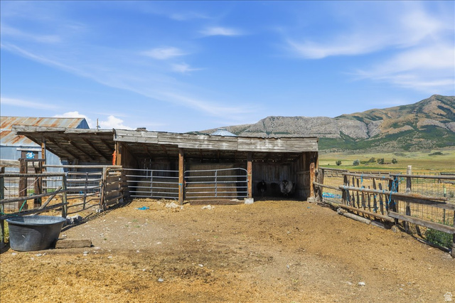 1634 West Arimo Road Arimo, ID 83214 - Photo 59 of 89 Spacious outdoor animal enclosure featuring wooden fencing and a large shelter with a corrugated metal roof