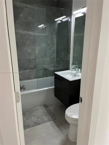 a living room with furniture a air conditioner and a window