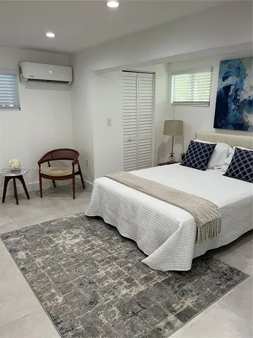 a bedroom with a bed and a chair