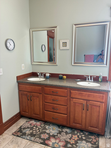 581 South 700 East Spring City, UT 84662 - Photo 16 of 42 Double vanity with warm-toned cabinetry, dual undermount sinks, and granite countertop