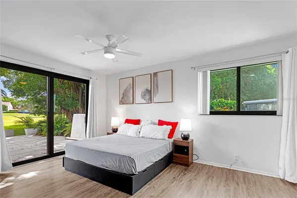 a bedroom with a bed and a large window with outer view