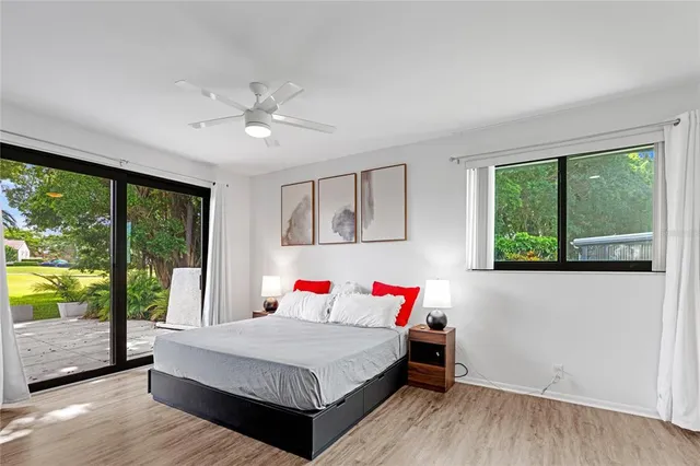 a bedroom with a bed and a large window with outer view