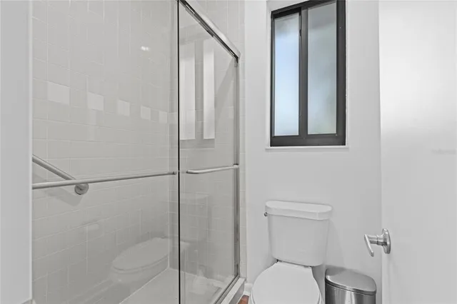 a bathroom with a toilet and a shower