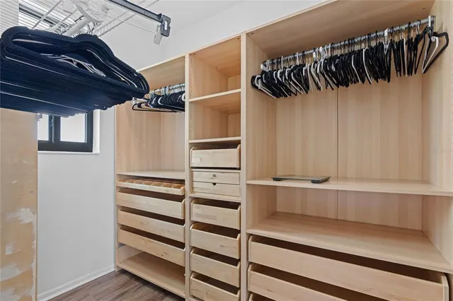 a view of walk in closet with empty racks