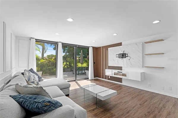 a living room with furniture and a large window