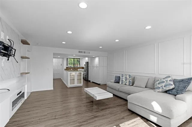 a living room with furniture and wooden floor