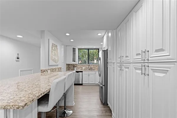 a kitchen with center island and stainless steel appliances