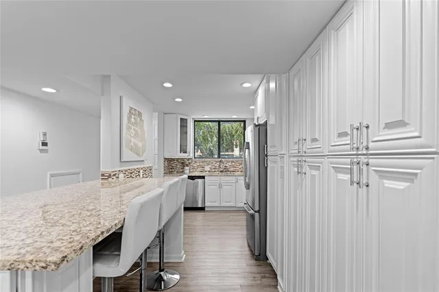 a kitchen with center island and stainless steel appliances