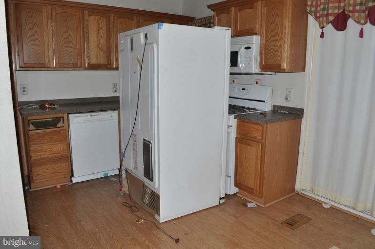 1023 Middlesex Road Essex, MD 21221 - Photo 1 of 7 a kitchen with stainless steel appliances a refrigerator and a stove