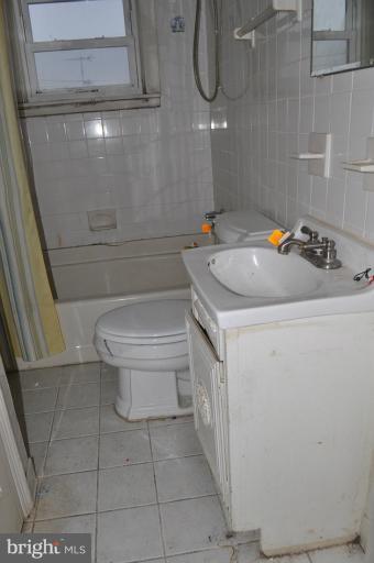 1023 Middlesex Road Essex, MD 21221 - Photo 2 of 7 a bathroom with a sink a toilet and shower