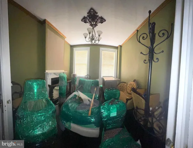 a living room with furniture and a chandelier