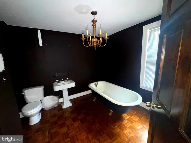 a bathroom with a sink mirror vanity and toilet