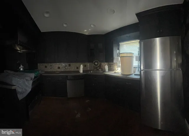 a kitchen with a refrigerator and a stove