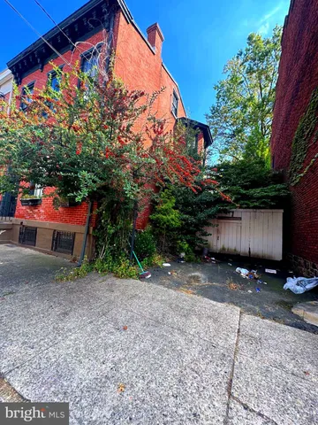 a backyard of a house with barbeque oven