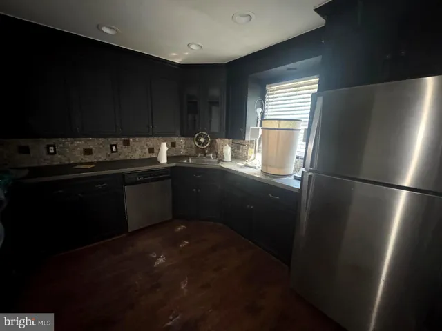 a kitchen with a sink stove and refrigerator