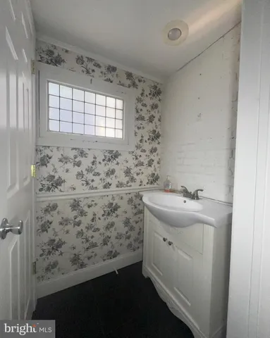 a bathroom with a sink and a window
