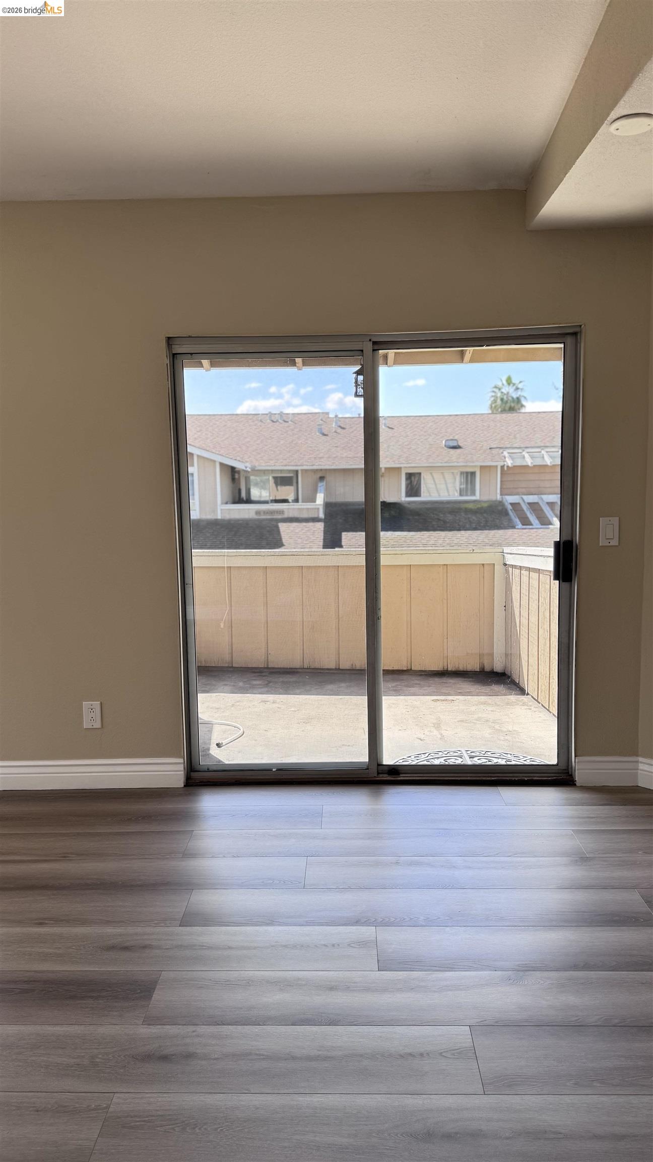 23 Raintree Court, Unit 15 Hayward, CA 94544 - Photo 11 of 16 Empty room featuring wood finished floors and healthy amount of natural light