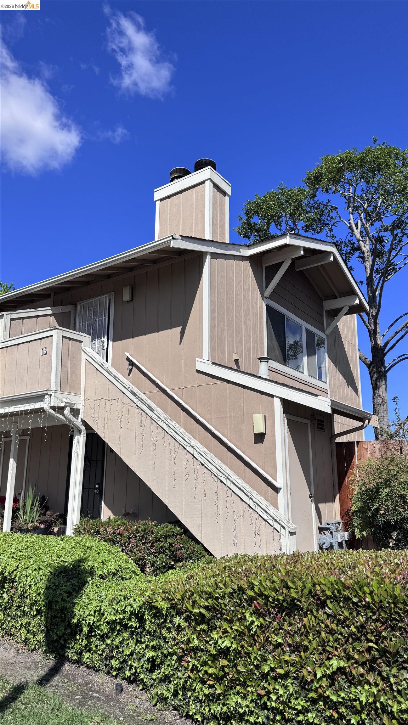 23 Raintree Court, Unit 15 Hayward, CA 94544 - Photo 14 of 16 View of side of home with a chimney and a balcony