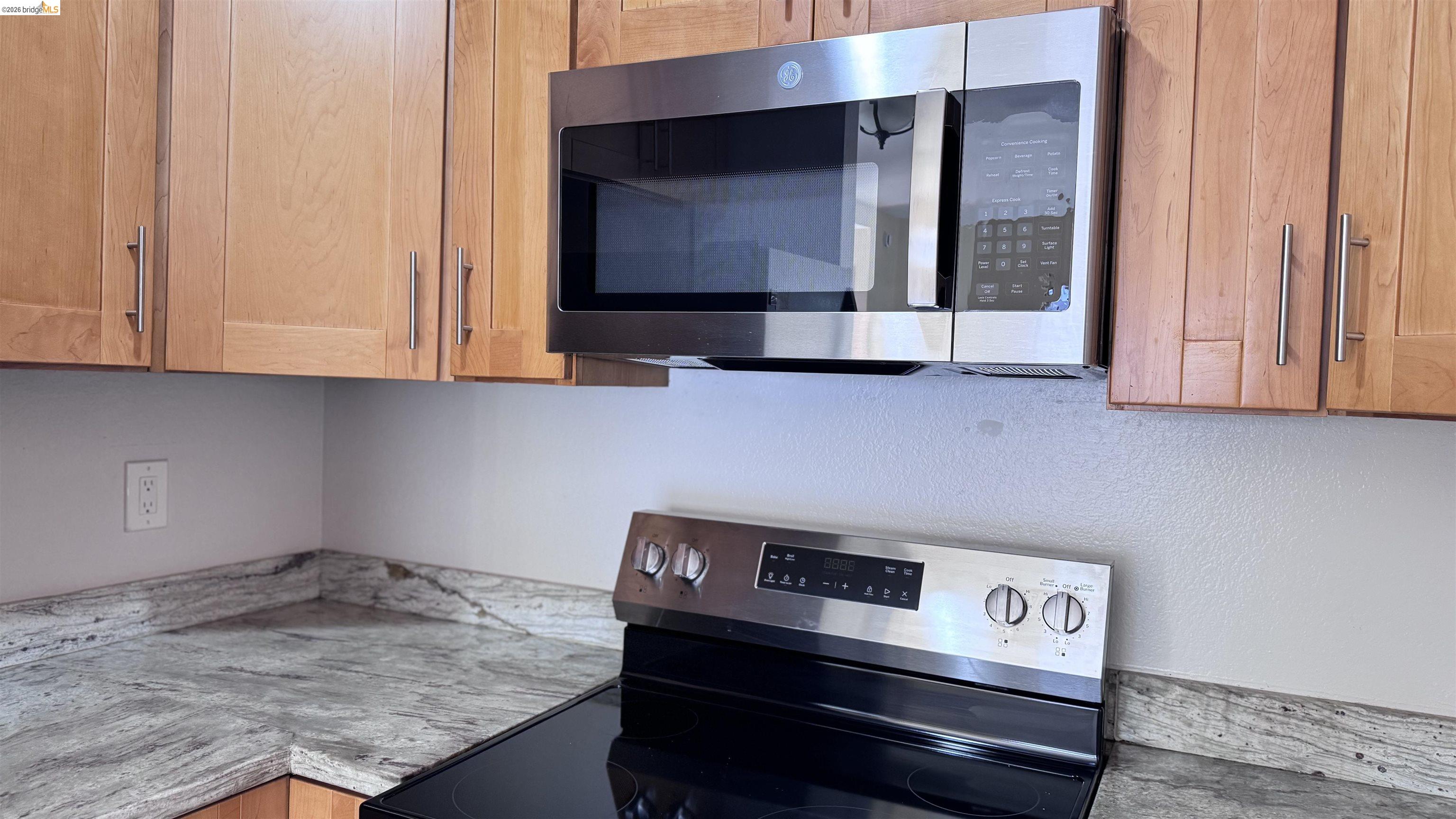 23 Raintree Court, Unit 15 Hayward, CA 94544 - Photo 3 of 16 Kitchen view of stainless steel appliances and light stone countertops