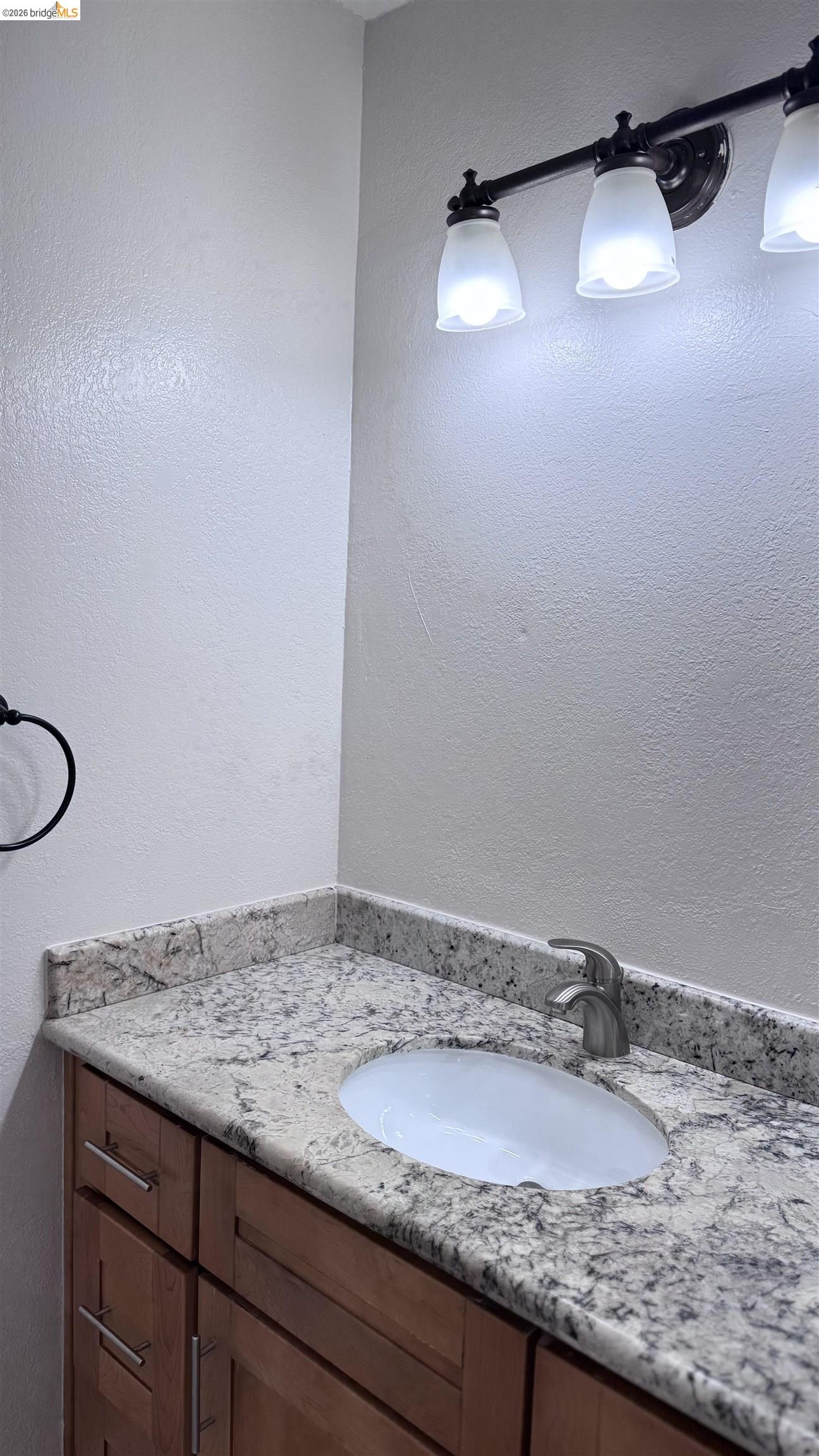 23 Raintree Court, Unit 15 Hayward, CA 94544 - Photo 8 of 16 Bathroom with vanity and a textured wall
