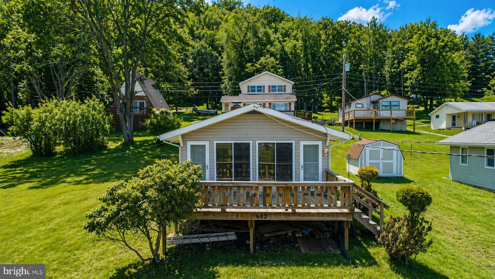 682 Marsh Hill Road McHenry, MD 21541 - Photo 1 of 40 a front view of a house with a yard table and chairs