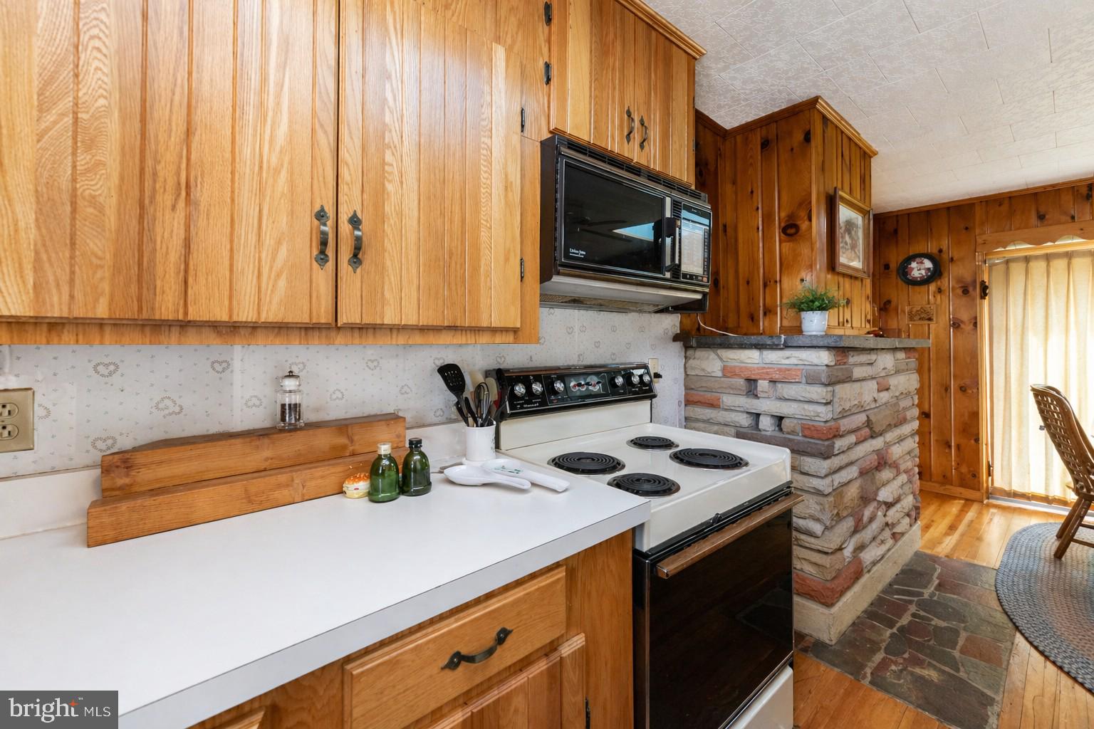 682 Marsh Hill Road McHenry, MD 21541 - Photo 17 of 40 a kitchen with stainless steel appliances a stove a microwave a sink and cabinets